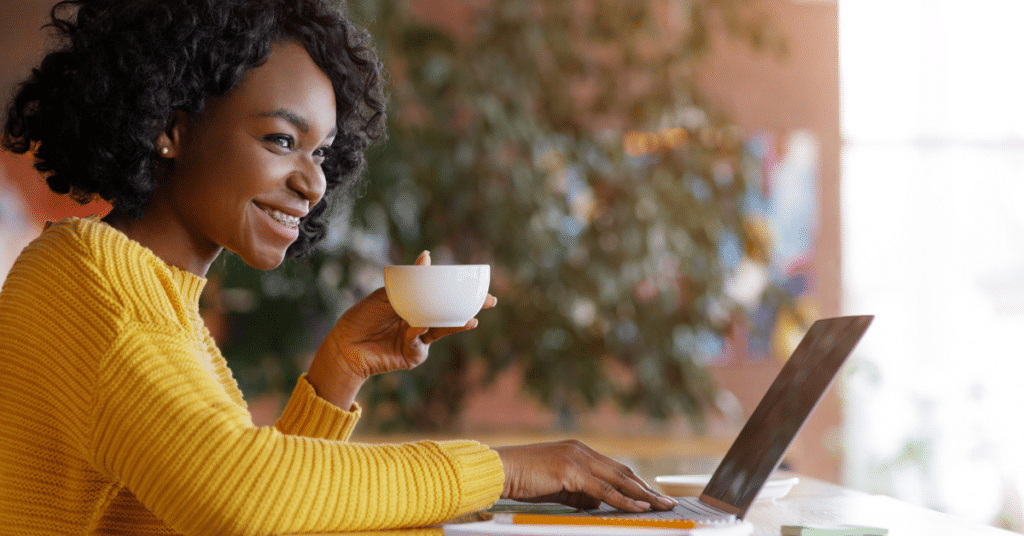 Person sitting at their computer smiling