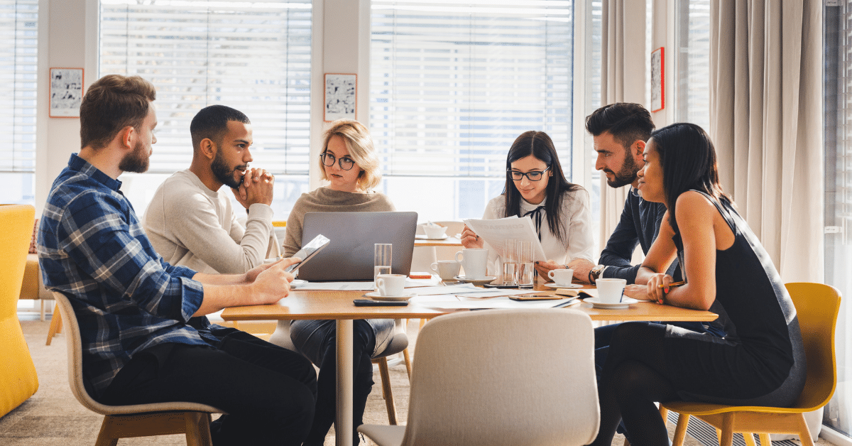 group of people meeting at a large conference table