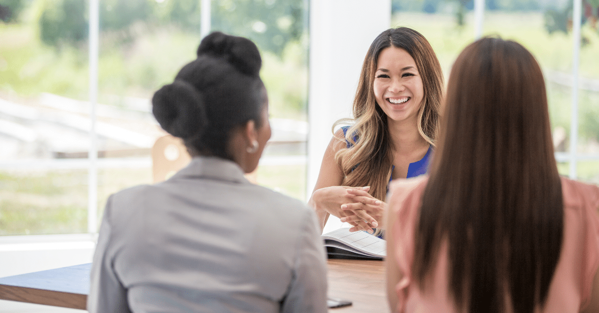 Three people at a business meeting