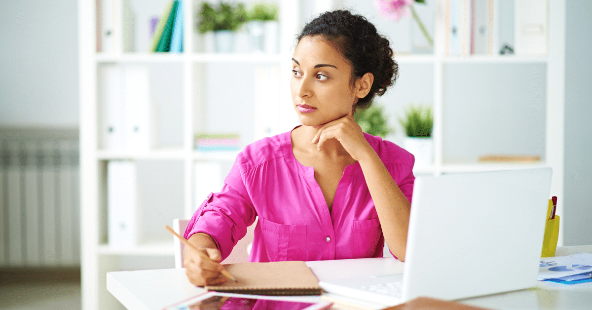 Person at computer deep in thought