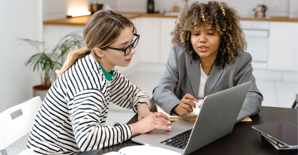 two people working together at a desk