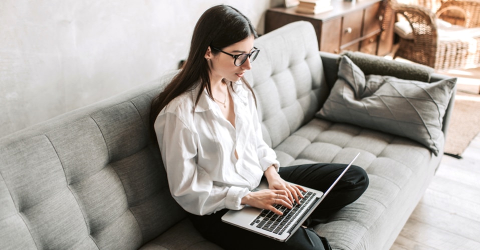 Person working on laptop on a couch