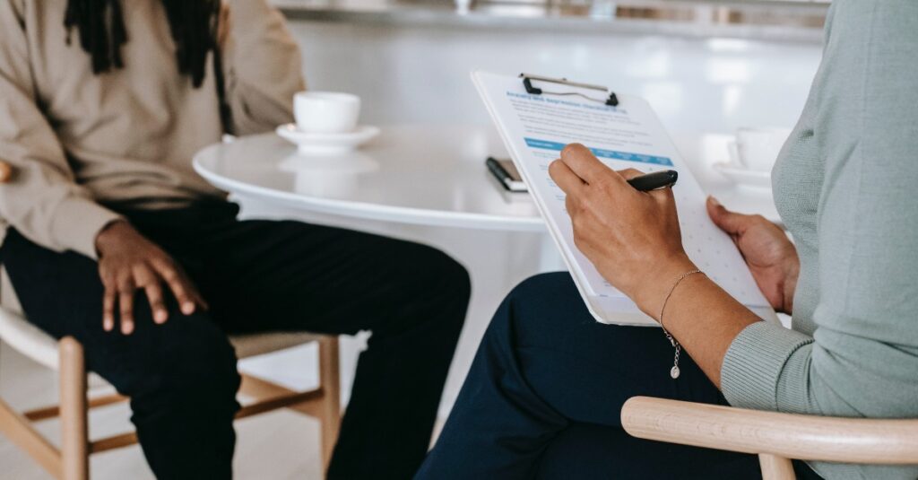 Two people at table interviewing